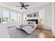 Bright main bedroom with hardwood floors, lots of natural light, modern furniture, and minimalist art at 101 E Lambright St, Tampa, FL 33604