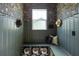 Cozy mudroom with floral wallpaper, built in bench with storage underneath, and hooks along the wall for coats and hats at 101 E Lambright St, Tampa, FL 33604