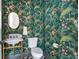 Elegant powder room featuring floral wallpaper, a pedestal sink with marble countertop, and gold fixtures at 101 E Lambright St, Tampa, FL 33604