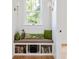 Cozy reading nook with built-in shelves and bench seat, lit by natural light from a window at 101 E Lambright St, Tampa, FL 33604