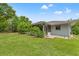 The expansive backyard with lush green grass and mature trees for shade at 10237 Carrin Rd, Spring Hill, FL 34608