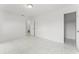Bright bedroom with modern tile flooring, white walls, and attached closet space for plenty of storage at 10237 Carrin Rd, Spring Hill, FL 34608