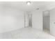 Spacious, bright bedroom with modern tile flooring and white walls, leading to other rooms at 10237 Carrin Rd, Spring Hill, FL 34608