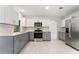 Modern kitchen with stainless steel appliances, granite countertops, and ample cabinet space at 10237 Carrin Rd, Spring Hill, FL 34608