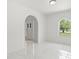 Bright, open living room with modern tile flooring and plenty of natural light at 10237 Carrin Rd, Spring Hill, FL 34608