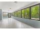 Spacious sunroom with ample natural light, tile flooring, and peaceful outdoor views at 10237 Carrin Rd, Spring Hill, FL 34608