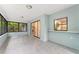 Bright sunroom with tile floor, glass windows, and sliding glass door at 10237 Carrin Rd, Spring Hill, FL 34608