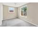 Clean bedroom with neutral colored walls, carpet flooring, and natural light shining through the window at 11896 104Th Ln, Largo, FL 33773