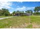 Charming single-story home with lawn, driveway, and a screened in porch at 11896 104Th Ln, Largo, FL 33773
