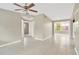 Bright living room features neutral paint, tile flooring, ceiling fan fixture, and views of another room at 11896 104Th Ln, Largo, FL 33773