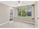 Sun room filled with lots of natural light, tile flooring, and views of the backyard and adjacent room at 11896 104Th Ln, Largo, FL 33773