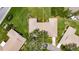 An aerial view highlights the property's boundaries, roof, surrounding greenery, and neighborhood layout at 1214 Haddington Cir # 1214, Sun City Center, FL 33573