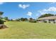 Expansive backyard with manicured lawn, beautiful landscaping, and ample space for outdoor activities at 1214 Haddington Cir # 1214, Sun City Center, FL 33573