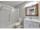 Bathroom featuring a shower with sliding glass doors, wood framed mirror, and updated vanity at 1214 Haddington Cir # 1214, Sun City Center, FL 33573