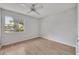 Bright bedroom featuring wood-look floors, a ceiling fan, and a window with natural light at 1214 Haddington Cir # 1214, Sun City Center, FL 33573