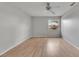 Bedroom features wood-look flooring, ceiling fan, and a window providing natural light at 1214 Haddington Cir # 1214, Sun City Center, FL 33573