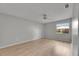 Bedroom with wood-look flooring, ceiling fan, and a window offering natural light and outdoor views at 1214 Haddington Cir # 1214, Sun City Center, FL 33573
