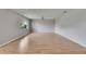 Spacious room featuring wood floors, a ceiling fan, neutral walls, and a large window for natural light at 1214 Haddington Cir # 1214, Sun City Center, FL 33573