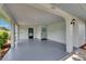 Inviting covered entrance featuring a light blue front door, updated flooring, and stylish lighting fixtures at 1214 Haddington Cir # 1214, Sun City Center, FL 33573