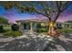 Charming home with a driveway, manicured lawn, and mature landscaping beneath a beautiful, large tree at 1214 Haddington Cir # 1214, Sun City Center, FL 33573