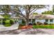 Charming single-story home with beautiful mature landscaping, lush lawn, and a shade tree at 1214 Haddington Cir # 1214, Sun City Center, FL 33573