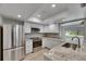 Modern kitchen with stainless steel appliances, granite countertops, and white cabinets at 1214 Haddington Cir # 1214, Sun City Center, FL 33573