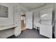 Bright laundry room with washer-dryer, utility sink, storage cabinet and built-in desk area at 1214 Haddington Cir # 1214, Sun City Center, FL 33573