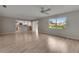 Open-concept living area showcasing hardwood floors, with seamless flow to kitchen and ample natural light at 1214 Haddington Cir # 1214, Sun City Center, FL 33573
