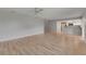 Bright living room with wood-look floors and a view of the adjacent kitchen at 1214 Haddington Cir # 1214, Sun City Center, FL 33573