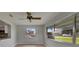Sunroom with large windows providing ample natural light and view to the lush landscaping at 1214 Haddington Cir # 1214, Sun City Center, FL 33573