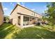This home features a screened in patio, lush green grass, and a view of the home's exterior at 1218 Grantham Dr, Sarasota, FL 34234