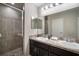 Bathroom with double sinks, tile backsplash, and glass-enclosed shower at 1218 Grantham Dr, Sarasota, FL 34234