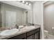 Bathroom featuring double sinks, granite counters, and neutral walls at 1218 Grantham Dr, Sarasota, FL 34234