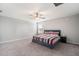 Bedroom with red, white, and blue striped comforter and ceiling fan at 1218 Grantham Dr, Sarasota, FL 34234
