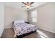 Bedroom with ceiling fan, window, and black bed frame with floral comforter at 1218 Grantham Dr, Sarasota, FL 34234