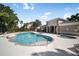 Resort-style community pool with lounge chairs and a nearby clubhouse, perfect for relaxing and socializing at 1218 Grantham Dr, Sarasota, FL 34234