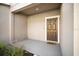 Welcoming covered front porch with a brown front door and neutral exterior paint at 1218 Grantham Dr, Sarasota, FL 34234