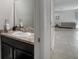Cozy half bath with a marble countertop and view to the home's living room at 1218 Grantham Dr, Sarasota, FL 34234