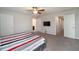 Spacious main bedroom with en-suite bathroom, tv, and carpeted floor at 1218 Grantham Dr, Sarasota, FL 34234