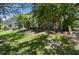 Spacious backyard featuring lush landscaping, a patio, and plenty of green space at 12472 Country White Cir, Tampa, FL 33635