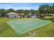 Recreational basketball court surrounded by trees and a nearby pool and cabana at 12472 Country White Cir, Tampa, FL 33635