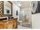 Stylish bathroom featuring a decorative mirror, elegant vanity, and glass block shower at 12472 Country White Cir, Tampa, FL 33635