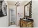 Elegant bathroom featuring an ornate mirror, decorative chandelier, and unique textured walls at 12472 Country White Cir, Tampa, FL 33635
