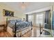 Bright bedroom with a decorative chandelier, large windows, and hardwood floors at 12472 Country White Cir, Tampa, FL 33635