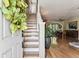 Warm, naturally lit entryway with hardwood floors and staircase leading to the second floor at 12472 Country White Cir, Tampa, FL 33635