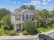 Inviting two-story townhouse featuring a covered front porch and lush tropical landscaping at 12472 Country White Cir, Tampa, FL 33635