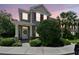 Charming two-story home features a well-manicured lawn and inviting entrance at sunset at 12472 Country White Cir, Tampa, FL 33635