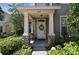 Inviting front porch with stone accents, fresh landscaping, and a wreath on the door at 12472 Country White Cir, Tampa, FL 33635