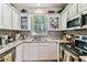 Bright kitchen featuring granite countertops, stainless steel appliances, and ample natural light at 12472 Country White Cir, Tampa, FL 33635