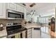 Well-equipped kitchen featuring stainless steel appliances, granite countertops, and stylish decorative lighting at 12472 Country White Cir, Tampa, FL 33635
